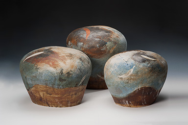 3 mound-shaped ceramic sculptural forms with landscape inspired surface decoration
